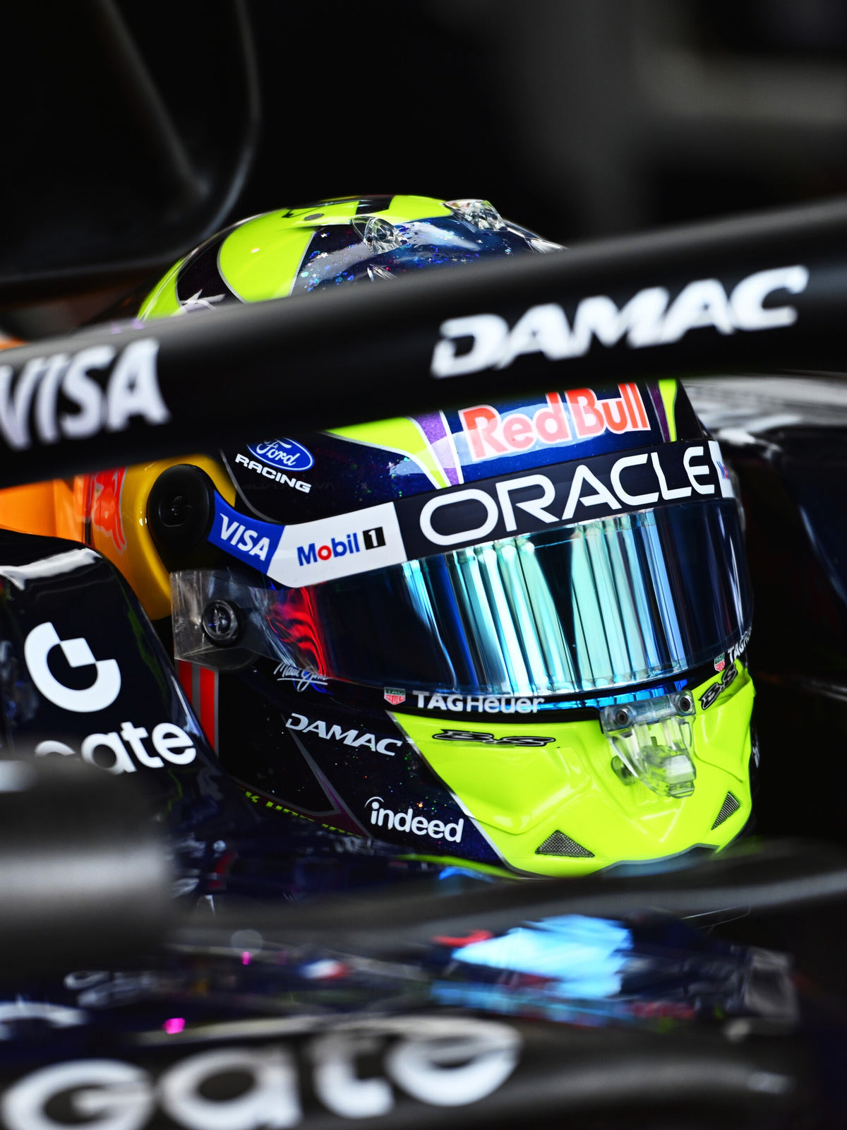 Isack Hadjar in the cockpit of his Oracle Red Bull Racing car, wearing his 2026 helmet