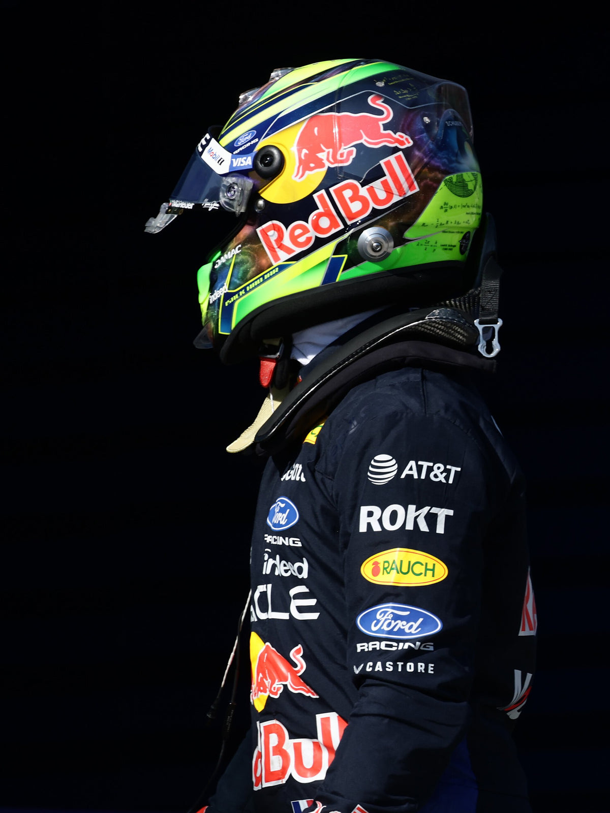 Isack Hadjar in profile, wearing his full-size 2026 helmet