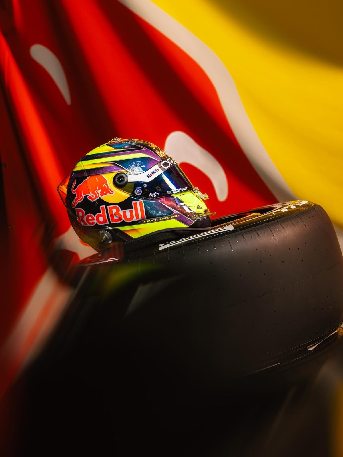 Isack Hadjar 2026 season helmet resting on a Formula 1 tyre